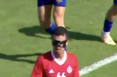 Soccer player wearing custom face mask in game